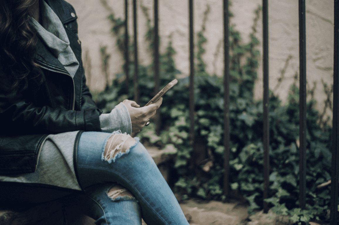 Single woman using dating apps on her mobile phone